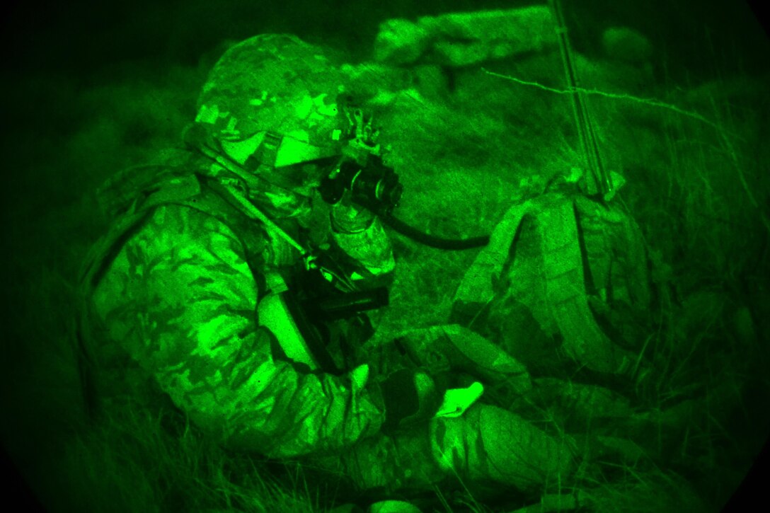 As seen through a night-vision device, a paratrooper conducts a radio check during a night live-fire exercise as part of Exercise Rock Sokol at Pocek Range in Postonja, Slovenia, March 9, 2016. The paratroopers are assigned to the 2nd Battalion, 503rd Infantry Regiment, 173rd Airborne Brigade. Exercise Rock Sokol is a bilateral training exercise between the U.S. Army 173rd Airborne Brigade and Slovenian armed forces that's focused on small-unit tactics and building on previous lessons learned, forging the bonds and enhancing readiness between allied forces. Army photo by Paolo Bovo