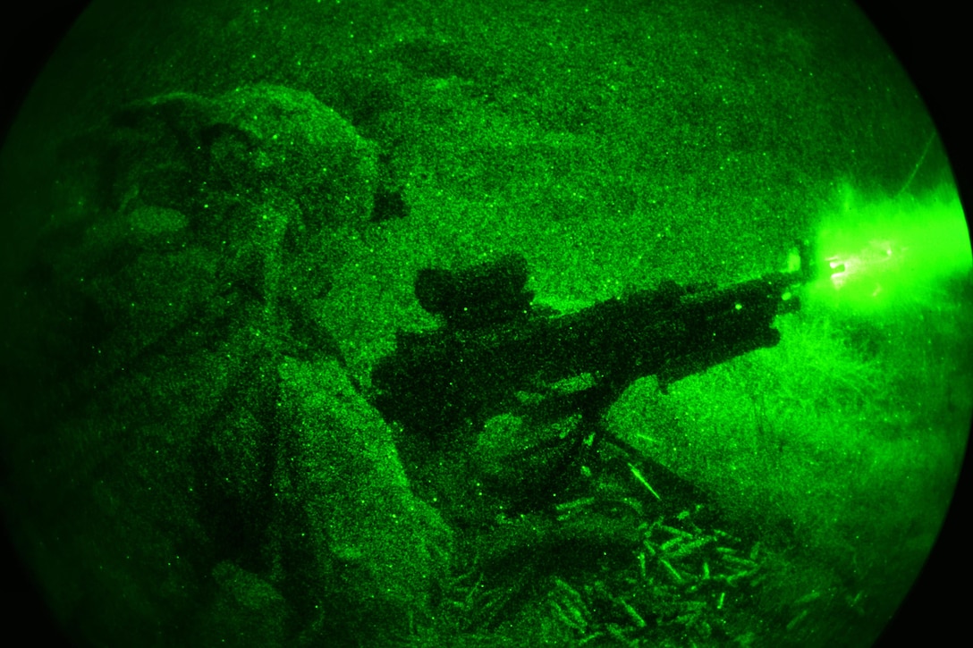 As seen through a night-vision device, a paratrooper fires his machine gun during a night live-fire exercise as part of Exercise Rock Sokol at Pocek Range in Postonja, Slovenia, March 9, 2016. Army photo by Paolo Bovo