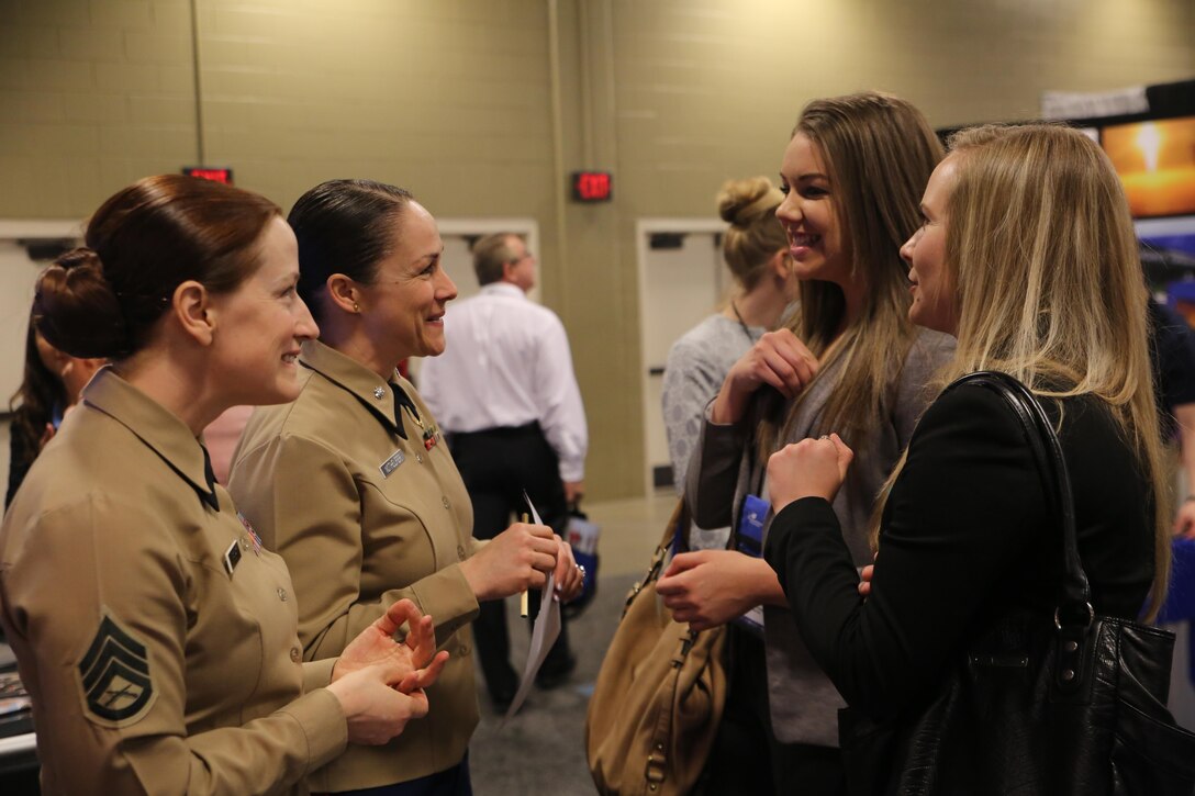 Staff Sgt. Nancy Wright (far left), and Lt. Col. Jenifer Nothelfer (middle left) speak with two attendees at the 2016 Women in Aviation International Symposium in Nashville, Tenn., March 10. This event gives Marines an opportunity to engage with young men and women who are interested in aviation careers and to let them know the Marine Corps is a viable option for them. Wright currently serves as the officer selection officer assistant, Recruiting Station Atlanta. Nothelfer currently serves as the recruiting support officer, Recruiting Station Des Moines.