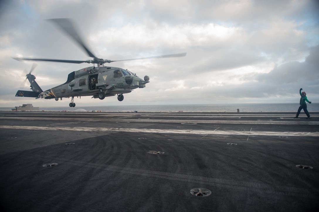 Navy Petty Officer 3rd Class Elizabeth Manrique directs the landing of an MH-60R Sea Hawk helicopter assigned to the Raptors of Helicopter Maritime Strike Squadron 71 on the flight deck of the aircraft carrier USS John C. Stennis in the South China Sea, March 6, 2016. Manrique is an aviation structural mechanic. Navy photo by Petty Officer 3rd Class Kenneth Rodriguez Santiago