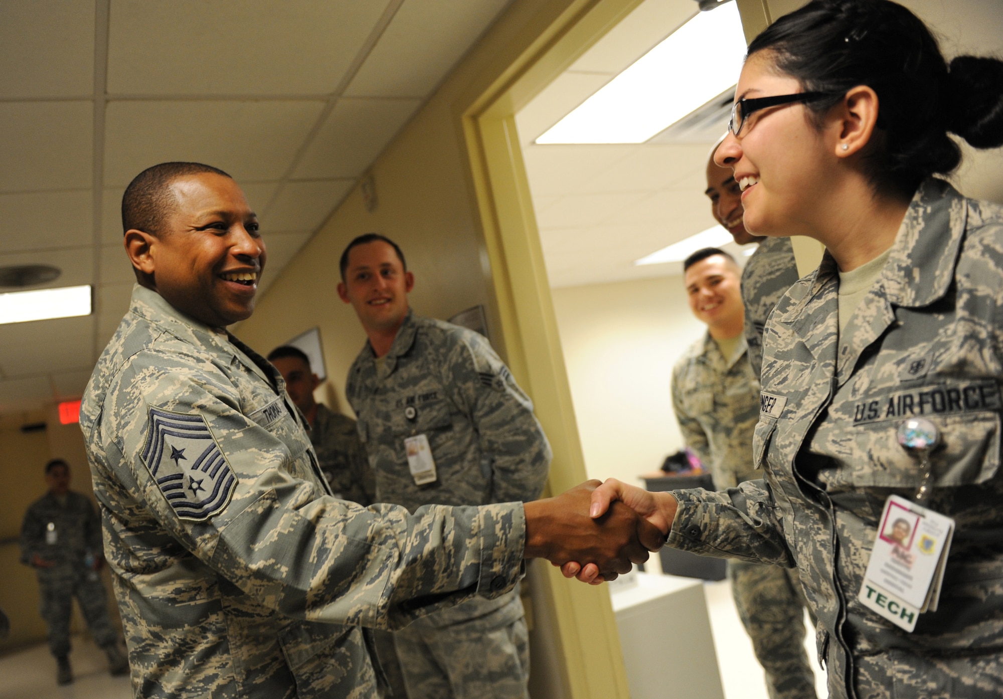 Chief Master Sgt. Farrell Thomas, 2nd Air Force command chief, recognizes Airman 1st Class Yvette Redinger, 81st Dental Squadron dental technician, by giving her a coin during an immersion tour at the Keesler Medical Center Mar.8, 2016, Keesler Air Force Base, Miss. Thomas visited the 81st Medical Group to become oriented with group missions, operations and personnel. (U.S. Air Force photo by Kemberly Groue)