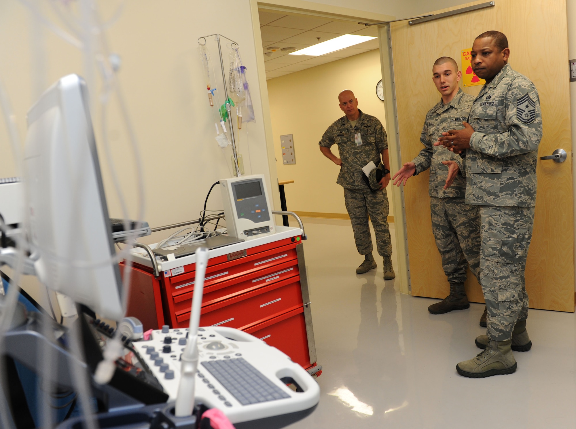 Col. Thomas Harrell, 81st Medical Group commander, stands by as Airman 1st Class David Wiley, 81st Medical Support Squadron biomedical equipment technician, provides Chief Master Sgt. Farrell Thomas, 2nd Air Force command chief, a tour inside the medical equipment repair shop during an immersion tour at the Keesler Medical Center Mar.8, 2016, Keesler Air Force Base, Miss. Thomas visited the 81st MDG to become oriented with group missions, operations and personnel. (U.S. Air Force photo by Kemberly Groue)