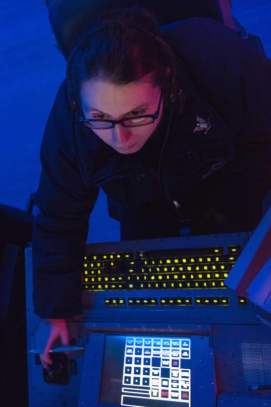 Navy Petty Officer 3rd Class Nichole Boik tracks surface contacts in the combat direction center aboard the aircraft carrier USS John C. Stennis in waters south of Japan, March 9, 2016. Boik is an operations specialist. Navy photo by Petty Officer 3rd Class Kenneth Rodriguez Santiago