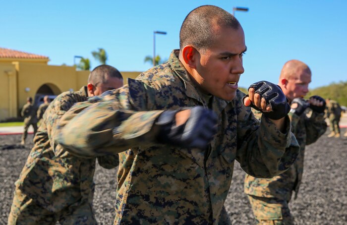 A recruit of Delta Company, 1st Recruit Training Battalion, conducts a right hook during a Marine Corps Martial Arts Program Test and Marine Corps Recruit Depot San Diego, March 9. The recruits conducted hand-to-hand combat techniques and learned various movements with knives as well as rifles. The tan belt is the first belt a Marine earns as a recruit, and they can eventually level up to earn the gray, green, brown and black belt later in their careers. Annually, more than 17,000 males recruited from the Western Recruiting Region are trained at MCRD San Diego. Delta Company is scheduled to graduate April 1.