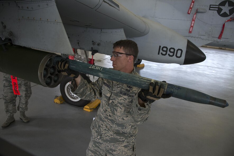 U.S. Air Force Tech. Sgt. Michael Sweeney, 23d Civil Engineer Squadron NCO in charge of equipment, removes a simulated hazard during a team-led qualification training, March 10, 2016, at Moody Air Force Base, Ga. The simulated hazard was an inert Mark 66 Rocket that failed to fire during a mission. (U.S. Air Force Photo by Airman 1st Class Janiqua P. Robinson/Released)