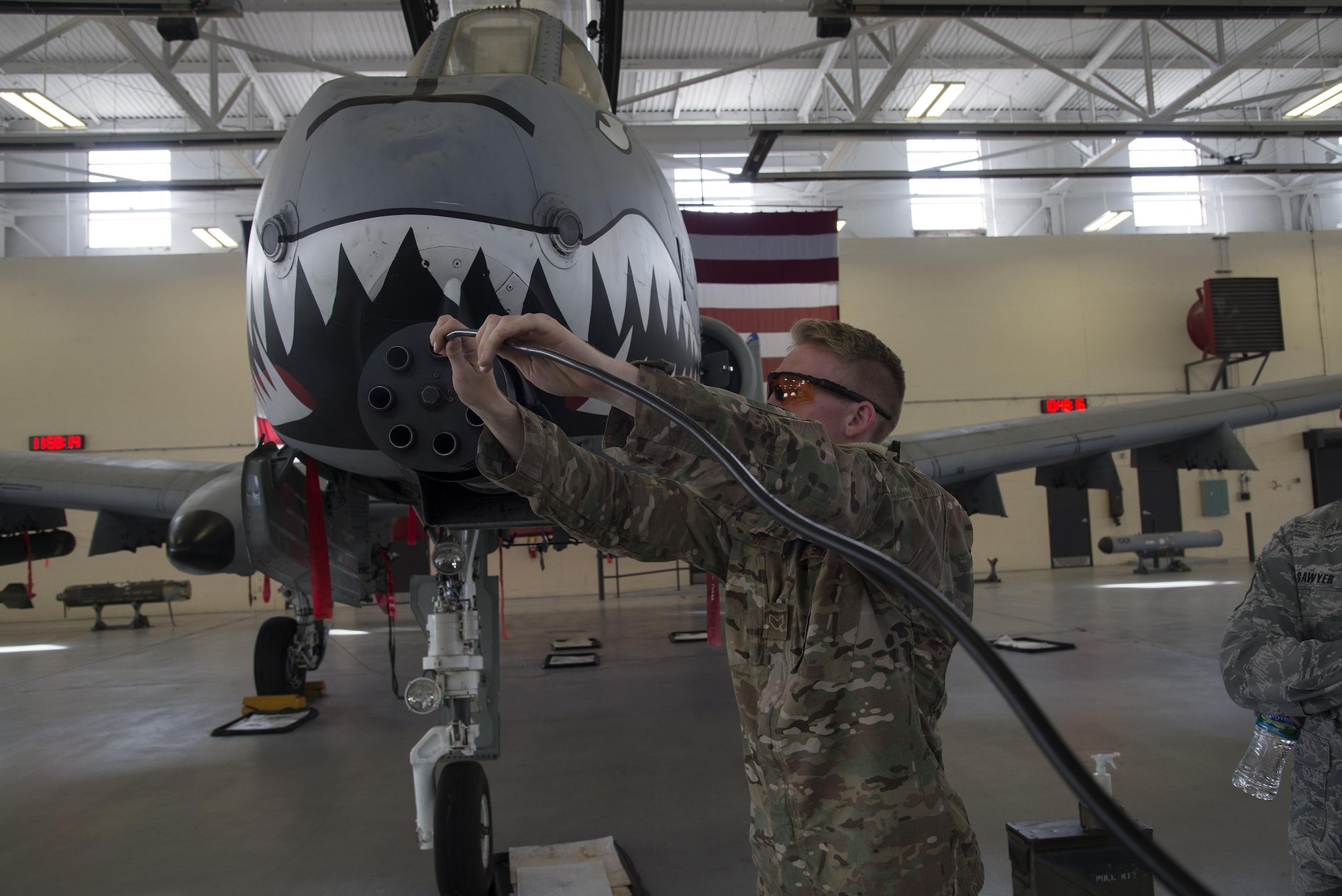 U.S. Air Force Senior Airman Kaelob King, 23d Civil Engineer Squadron explosive ordinance disposal apprentice, inserts a fiberscope into the GAU-8 autocannon of an A-10C Thunderbolt II during a team-led qualification training, March 10, 2016, at Moody Air Force Base, Ga. EOD team members used the fiberscope to look inside the GAU-8 Avenger autocannon and see if there were hazardous items stuck. (U.S. Air Force Photo by Airman 1st Class Janiqua P. Robinson/Released)