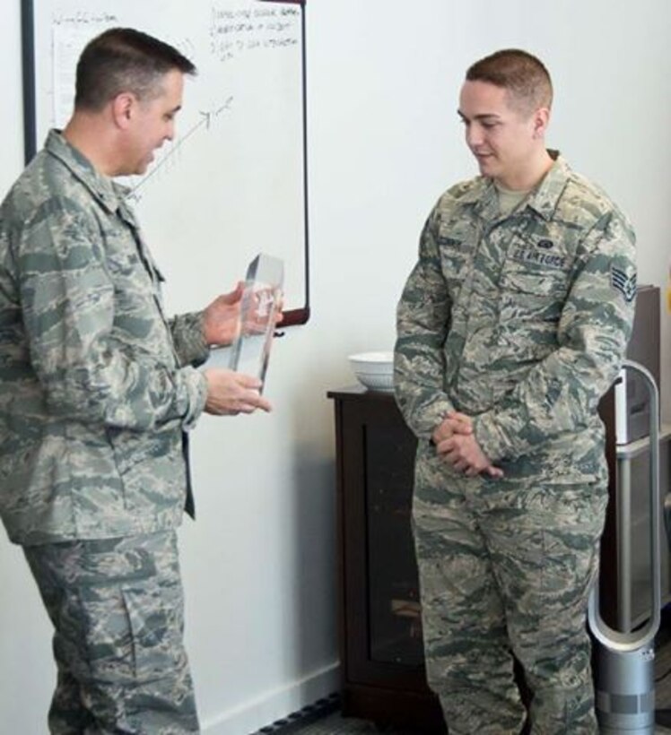 Staff Sgt. Patrick O'Connor, Air Reserve Personnel Center DD 214 service technician, is presented the 2015 Air National Guard Readiness Center Airman of the Year award by Brig. Gen. Michael Taheri, ANGRC commander, Feb. 26, 2016, at Joint Base Andrews, Md. (Air Force courtesy photo)