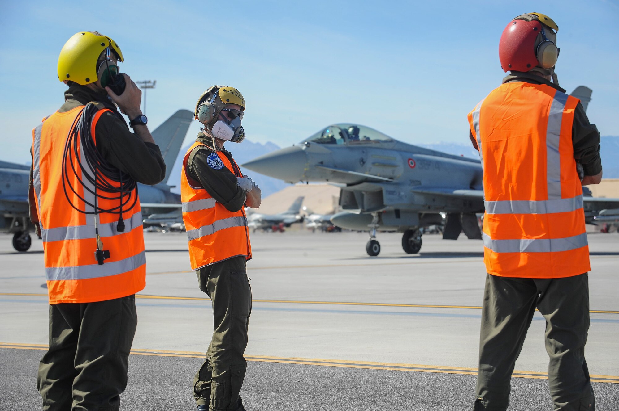 Crew members from the 4th Fighter Wing, Grosseto, Italy, conducts pre-flight checks in preparation for take-off during Red Flag 16-2 March 3, 2016 at Nellis Air Force Base, Nev. Red Flag provides an opportunity for aircrew and maintainers to enhance their tactical operational skills alongside military aircraft from coalition forces. (U.S. Air Force photo by Senior Airman Jake Carter)