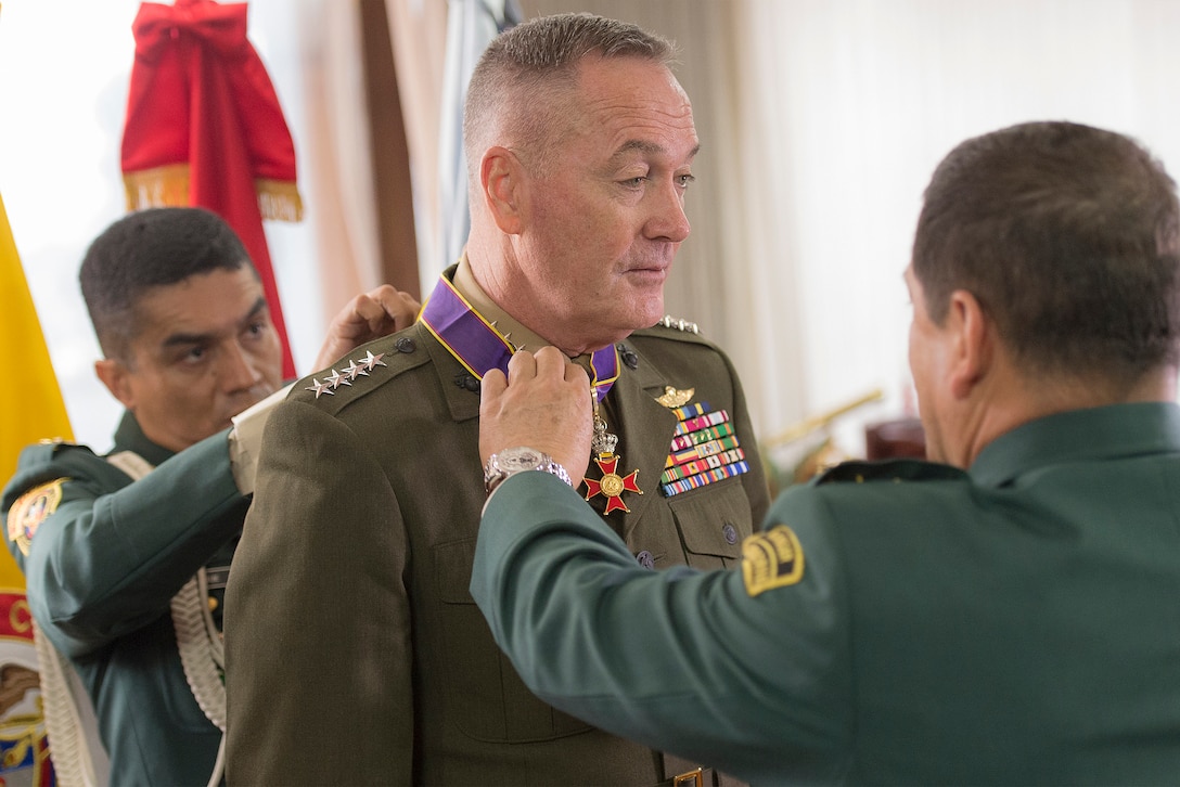 The commander of Colombia's armed forces, Gen. Juan Pablo Rodriguez, presents the Fe en La Causa, or Faith in the Cause, medal to Marine Corps Gen. Joseph F. Dunford Jr., chairman of the Joint Chiefs of Staff, in Bogota, Colombia, March 10, 2016. Dunford received the medal for his support of Colombian military efforts. DoD photo by Navy Petty Officer 2nd Class Dominique A. Pineiro