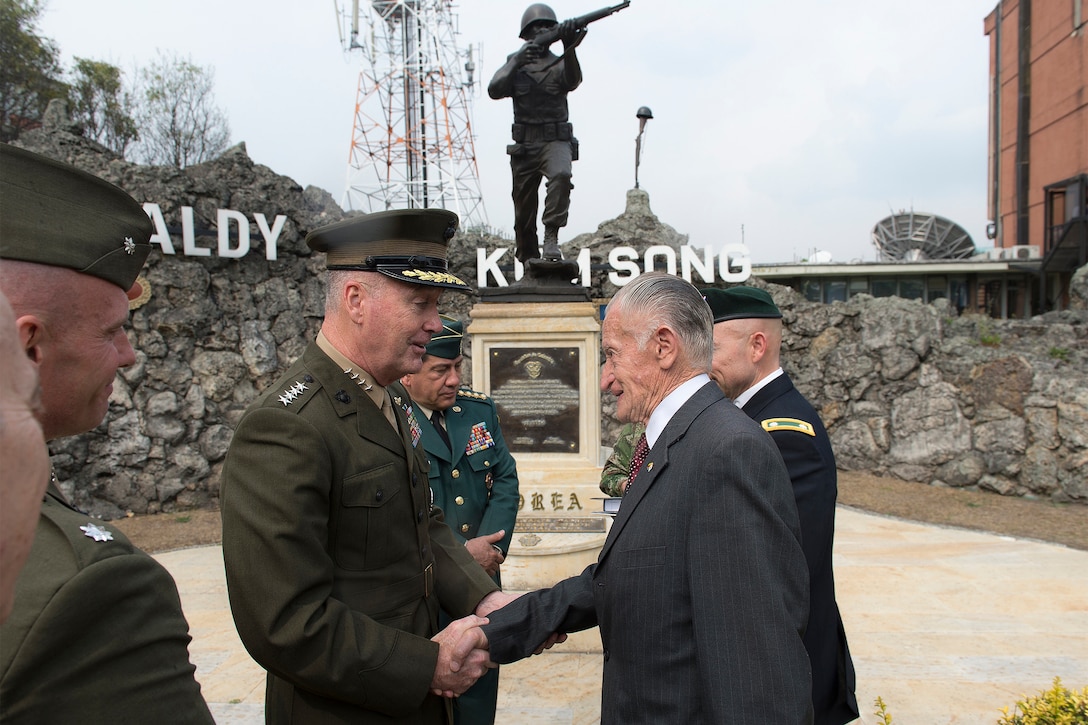 Marine Corps Gen. Joseph F. Dunford Jr., chairman of the Joint Chiefs of Staff, talks with a Colombian veteran of the Korean War at the Korean War memorial in Bogota, Colombia, March 10, 2016. DoD photo by Navy Petty Officer 2nd Class Dominique A. Pineiro