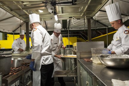 U.S. Army Reserve Culinary Arts Team members have specific jobs and responsibilities during the Military Hot Food Kitchen category at the 41st Annual Military Culinary Arts Competitive Training Event, March 10, 2016, at Fort Lee, Va.. The team prepared Roasted Golden and Burgundy Beet Salad, Coq au Vin Nuevo (Chicken braised in red wine), and Molten Lava Cake working on a Mobile Kitchen Trailer for 45 dining guests. (U.S. Army photo by Timothy L. Hale/Released)