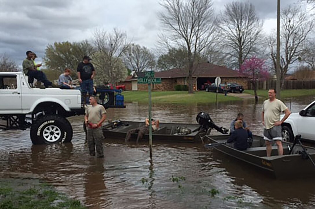 U.S. Air Force Airmen from the 307th and 2nd Bomb Wing, Barksdale Air Force Base, La., help local flood victims on March 10, 2016. Residents of the Golden Meadows sub-division in Bossier City received assistance with sand bags and transportation through the flooded streets. The area received between 12 to 18 inch of rain in two days. (Courtesy photo)