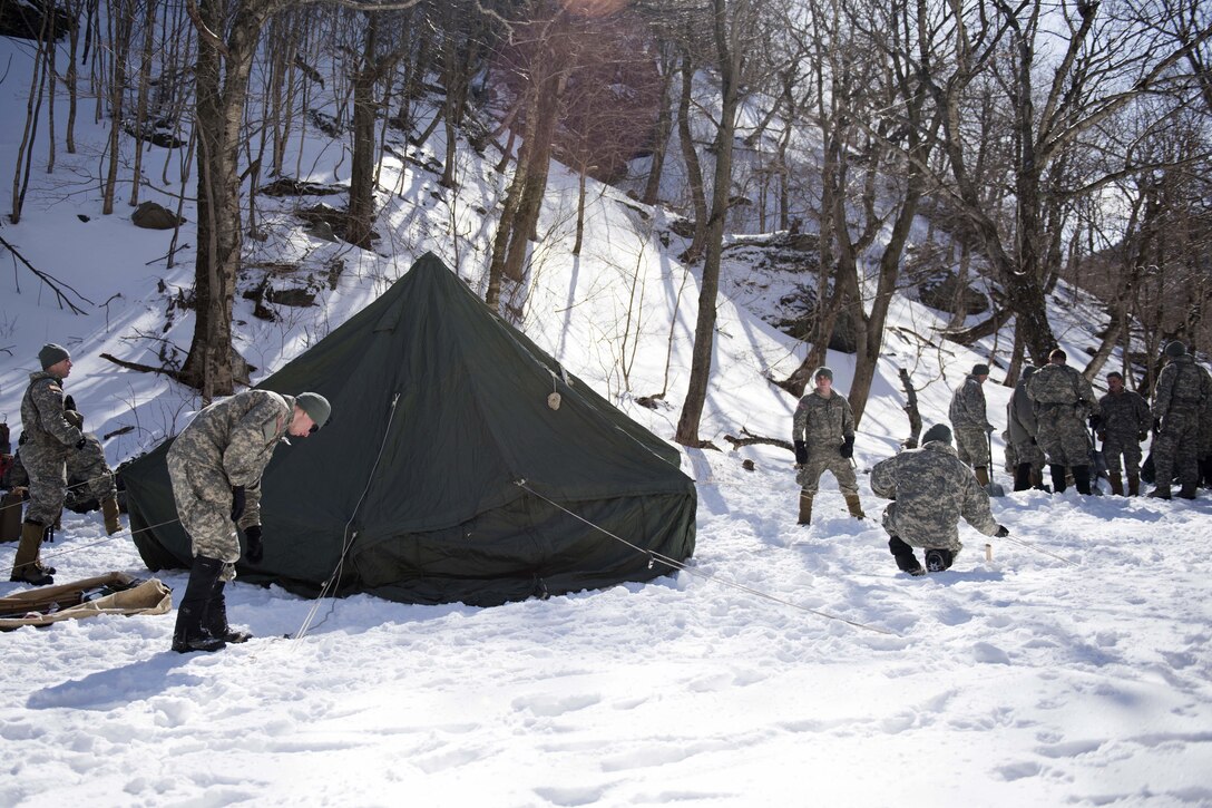 Soldiers establish a campsite for the night during their bivouac at Smugglers' Notch in Jeffersonville, Vt., March 5, 2016. Vermont Army National Guard photo by Staff Sgt. Nathan Rivard