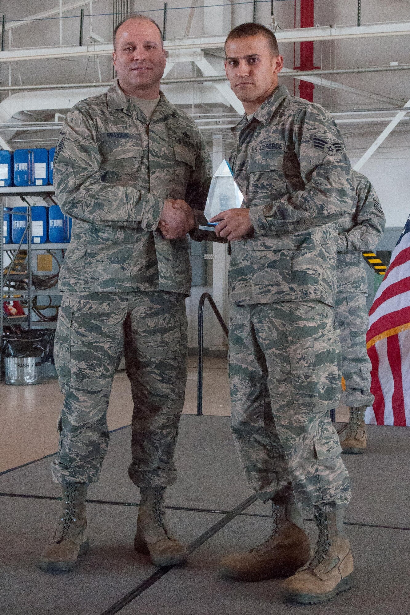 U.S. Air Force Master Sgt. Andrew Branning, the first sergeant for the 307th Operations Support Squadron, awards the Diamond Sharp Award for the 4th Quarter to Senior Airman Jeremy Foreman of the 307th Civil Engineer Squadron. Foreman received the award on March 6, 2015 on Barksdale Air Force Base, La. during the 307th Bomb Wing Commander’s Call. (U.S. Air Force photo by Master Sgt. Dachelle Melville/Released)