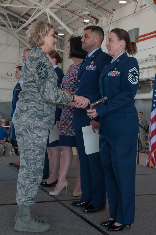 U.S. Air Force Chief Master Sgt. Shelley Cohen, the 307th Bomb Wing command chief, congratulates Senior Master Sgt. Melissa Hubbard, the first sergeant for the 307th Aircraft Maintenance Squadron, on being awarded the 2015 First Sergeant of the Year.  Hubbard was recognized during the March 6th Wing Commander’s Call on Barksdale Air Force Base, La. (U.S. Air Force photo by Master Sgt. Dachelle Melville/Released)