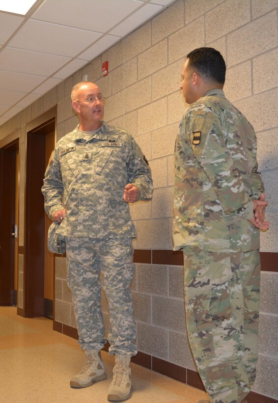 Staff Sgt. Hector Marrero, 80th Training Command, listens to guidance from Command Sgt. Maj. Jeff Darlington, senior noncommissioned officer 80th TC, at The Army School System Training Center, Grand Prairie, Texas, March 7, 2016. Darlington congratulated Marrero during a visit to the TTC after learning that the Information Technology Specialist landed a job in the civilian sector as an IT Analyst.