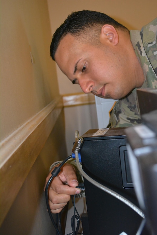 Staff Sgt. Hector Marrero an Information Technology Specialist assigned to the 80th Training Command, works on personal computer at The Army School System Training Center, Grand Prairie, Texas, March 7, 2016.