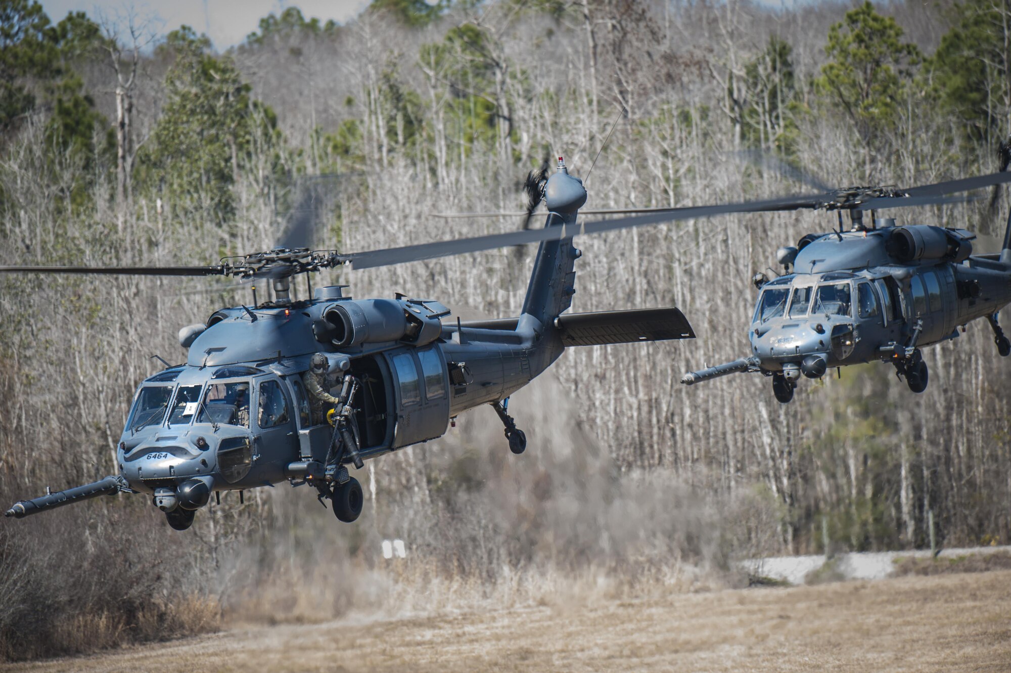 Airmen from the 41st Rescue Squadron take off in HH-60G Pave Hawk helicopters during a training exercise, Jan. 26, 2016, at Moody Air Force Base, Ga. The primary mission of the HH-60G is to conduct rescue operations in hostile environments to recover isolated personnel. (U.S. Air Force photo by Airman 1st Class Lauren M. Johnson/Released)