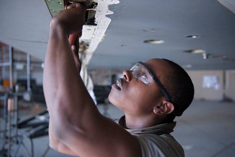 Airman John Ellis, 455th Expeditionary Aircraft Maintenance Squadron crew chief, works to remove a retaining pin from a leading edge flap on the wing of an F-16 Fighting Falcon assigned to the 421st Expeditionary Fighter Squadron during a phase inspection at Bagram Airfield, Afghanistan, Feb. 24, 2016. Ellis worked with several other crew chiefs to check for corrosion and complete an 8000-hour rotary actuator time change. (U.S. Air Force photo/Tech. Sgt. Robert Cloys)
