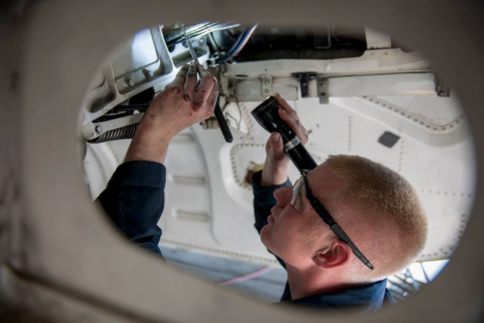 Tech. Sgt. Greggory Myers, 455th Expeditionary Aircraft Maintenance Squadron crew chief, performs a 400-hour phase inspection of landing gear on an F-16 Fighting Falcon assigned to the 421st Expeditionary Fighter Squadron at Bagram Airfield, Afghanistan, Feb. 24, 2016. The 455th EAMXS ensures aircraft are prepared for flight and return them to a mission-ready state once they land. (U.S. Air Force photo/Tech. Sgt. Robert Cloys)