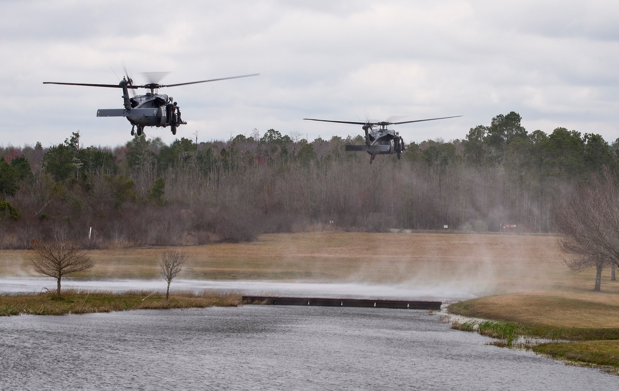 Two HH-60 Pave Hawks land at Moody Air Force Base, Ga., Mar. 4, 2016. Multiple U.S. Air Force aircraft within Air Combat Command conducted joint aerial training that showcased the aircrafts tactical air and ground maneuvers, as well as its weapons capabilities. (U.S. Air Force photo by Staff Sgt. Brian J. Valencia/Released)