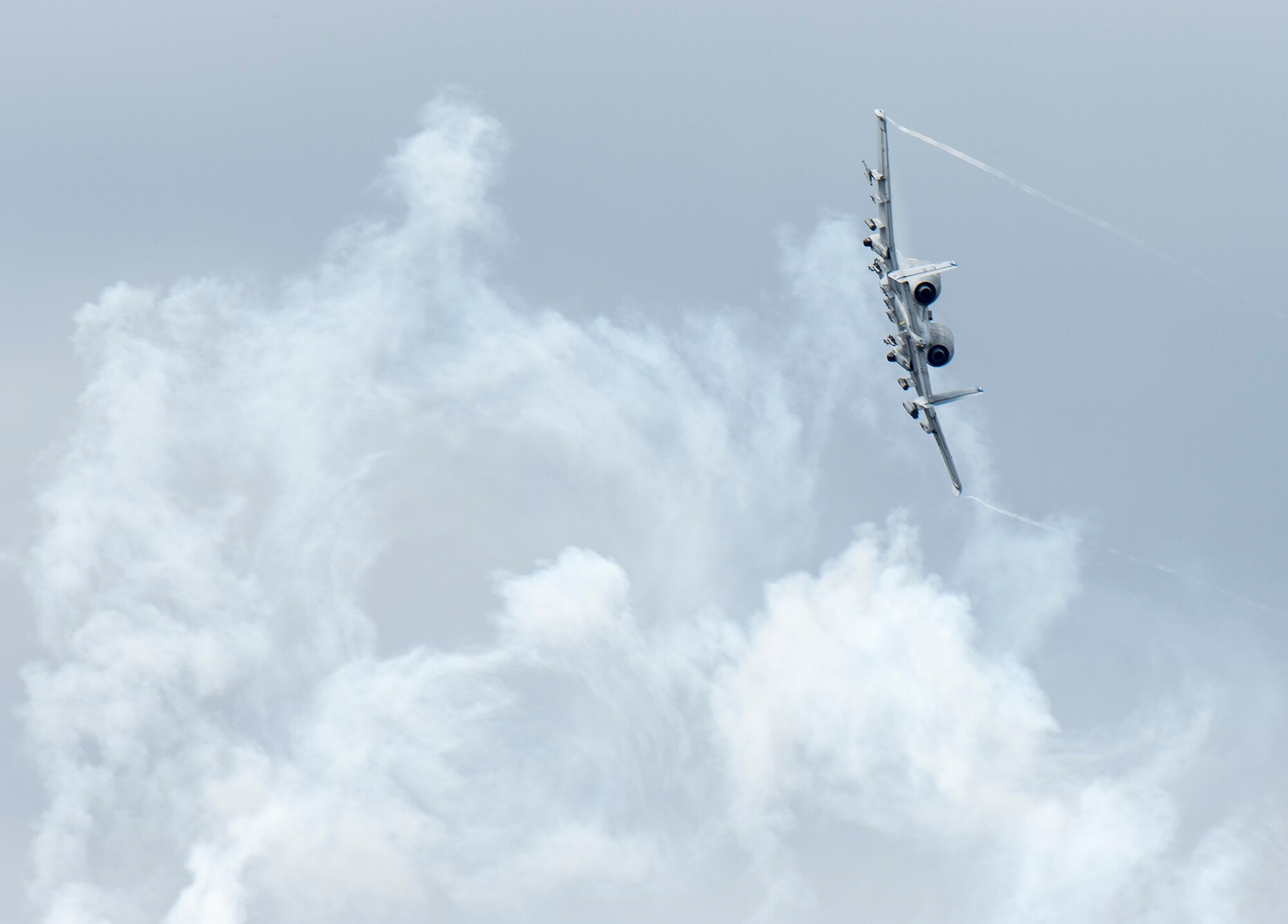 An A-10 Thunderbolt II banks through flare smoke over Grand Bay Bombing and Gunnery Range at Moody Air Force Base, Ga., Feb. 18, 2016. Multiple U.S. Air Force aircraft within Air Combat Command conducted joint aerial training that showcased the aircrafts tactical air and ground maneuvers, as well as its weapons capabilities. (U.S. Air Force photo by Staff Sgt. Brian J. Valencia/Released)