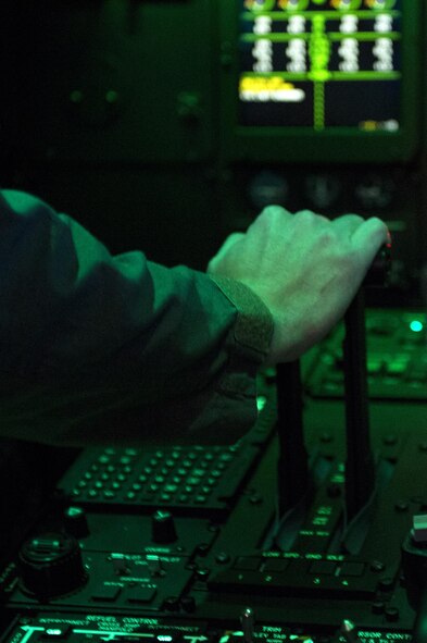 U.S. Air Force Capt. Cory Pilinko, 347th Operations Support Squadron HC-130J Combat King II aircraft commander, demonstrates the new HC-130J simulator for Col. Thomas Kunkel, 23d Wing commander, March 10, 2016, at Moody Air Force Base, Ga. The cost effective simulator provides a safer way for aircrew to practice training scenarios. (U.S. Air Force photo by Airman 1st Class Kathleen D. Bryant/Released)