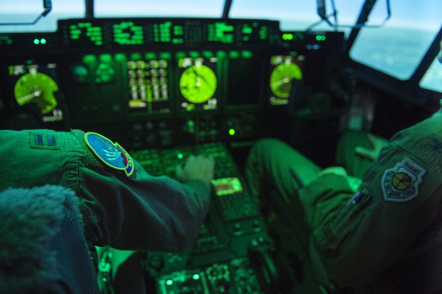 A 347th Operations Support Squadron pilot accelerates while in an HC-130J Combat King II simulator during a demonstration, March 10, 2016, at Moody Air Force Base, Ga. The simulator displays graphics of airspaces all over the world and physically mimics the movement of the actual aircraft in any scenario. (U.S. Air Force photo by Airman 1st Class Kathleen D. Bryant/Released)