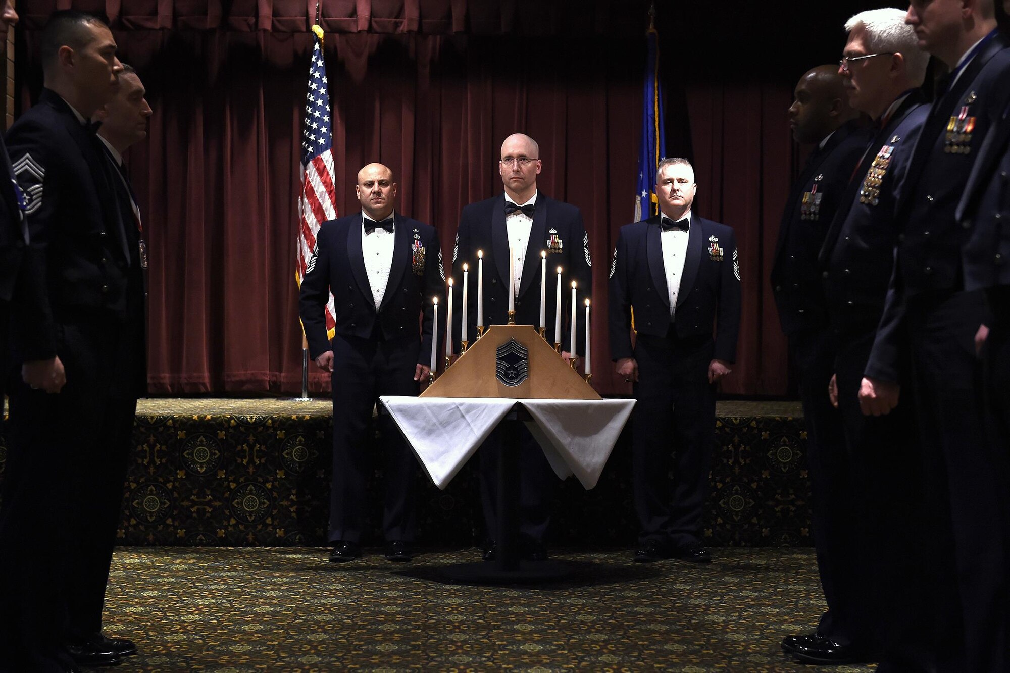 From left: Chief Master Sgt. Zaki Mazid, 62th Airlift Wing command chief, Chief Master Sgt. Brian Waggoner, 194th Wing command chief, and Chief Master Sgt. Tony Mack, 446th Airlift Wing command chief conclude a candle lighting ceremony during the Chief Master Sergeant Induction Ceremony here, March 4, 2016. The event celebrates Airmen who achieved the rank of chief master sergeant during the previous year. An Airman from each enlisted rank lights a candle symbolizing the path to chief master sergeant. (U.S. Air Force photo by Tech. Sgt. Tim Chacon)

[The 446th Airlift Wing Public Affairs Office contributed to this stand-alone article.]