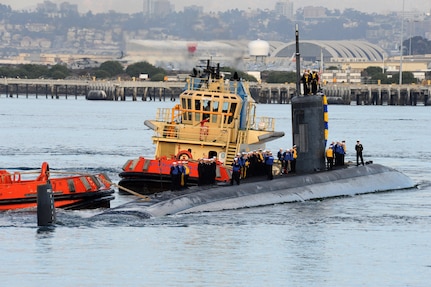 SAN DIEGO (December 18, 2013)  The Los Angeles-class attack submarine USS Hampton (SSN 767) is guided in by tugs as it returns to Naval Base Point Loma following a six-month deployment to the western Pacific region. U.S. Navy photo by Mass Communication Specialist 2nd Class Kyle Carlstrom (Released)