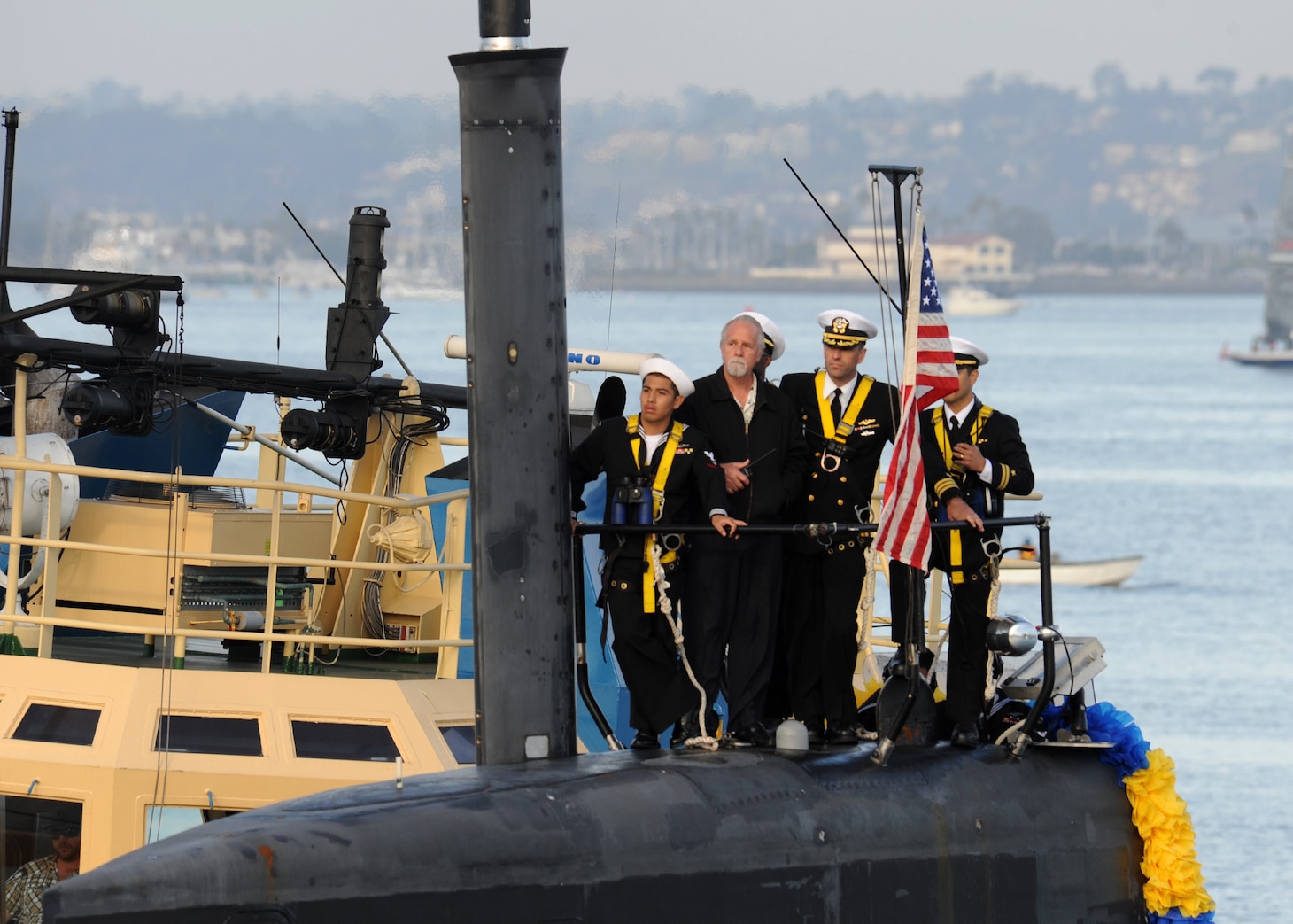 SAN DIEGO (December 18, 2013)  Cdr. Lincoln Reifsteck, commanding officer of the Los Angeles-class attack submarine USS Hampton (SSN 767) stands on the bridge as the Hampton pulls pierside following a six-month deployment to the western Pacific region. U.S. Navy photo by Mass Communication Specialist 2nd Class Kyle Carlstrom (Released)