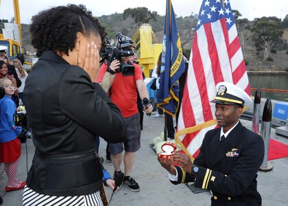 SAN DIEGO (December 18, 2013)  Lt.j.g. Justin Gay proposes to his girlfriend Cynthia Fambro following the return of the Los Angeles-class attack submarine USS USS Hampton (SSN 767) to Naval Base Point Loma after completing a six-month deployment to the western Pacific region. U.S. Navy photo by Mass Communication Specialist 2nd Class Kyle Carlstrom (Released)