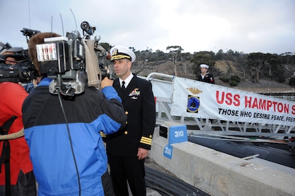 SAN DIEGO (December 18, 2013)  Cdr. Lincoln Reifsteck, commanding officer of the Los Angeles-class attack submarine USS Hampton (SSN 767) answers questions during an interview with local media following a six-month deployment to the western Pacific region. U.S. Navy photo by Mass Communication Specialist 2nd Class Kyle Carlstrom (Released)