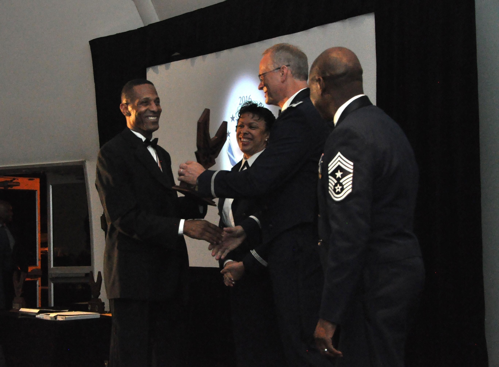 Civilian of the year receives his AF wings with a big smile, March 5, 2016.The ceremony recognized individuals in seven categories who demonstrated the capability to excel and made significant contributions to their units and the wing.  (U.S. Air Force photo by Senior Airman Lauren Douglas)