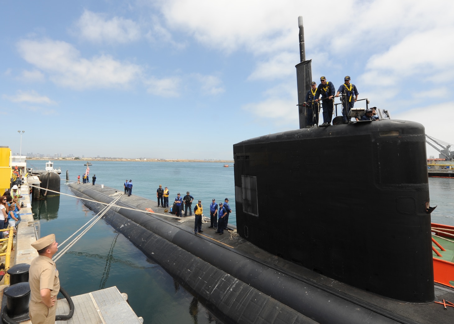 SAN DIEGO (June 18, 2013) Capt. Thomas Ishee, commander Submarine Squadron 11 (lower left) talks to Cmdr. Lincoln Reifsteck, commanding officer of the Los Angeles-class attack submarine USS Hampton (SSN 767), as the boat prepares to depart for a scheduled six-month deployment to the western Pacific region in support of the Chief of Naval Operations' Maritime Strategy, which includes maritime security, forward presence, sea control, and power projection. Hampton was commissioned November 16, 1993 and is named after Hampton, Iowa, S.C. and Va. Displacing more than 6,900 tons, Hampton has a crew of nearly 140 Sailors and is one of six Los Angeles-class, fast-attack submarines homeported in San Diego. U.S. Navy photo by Mass Communication Specialist 2nd Class Kyle Carlstrom. (Released)