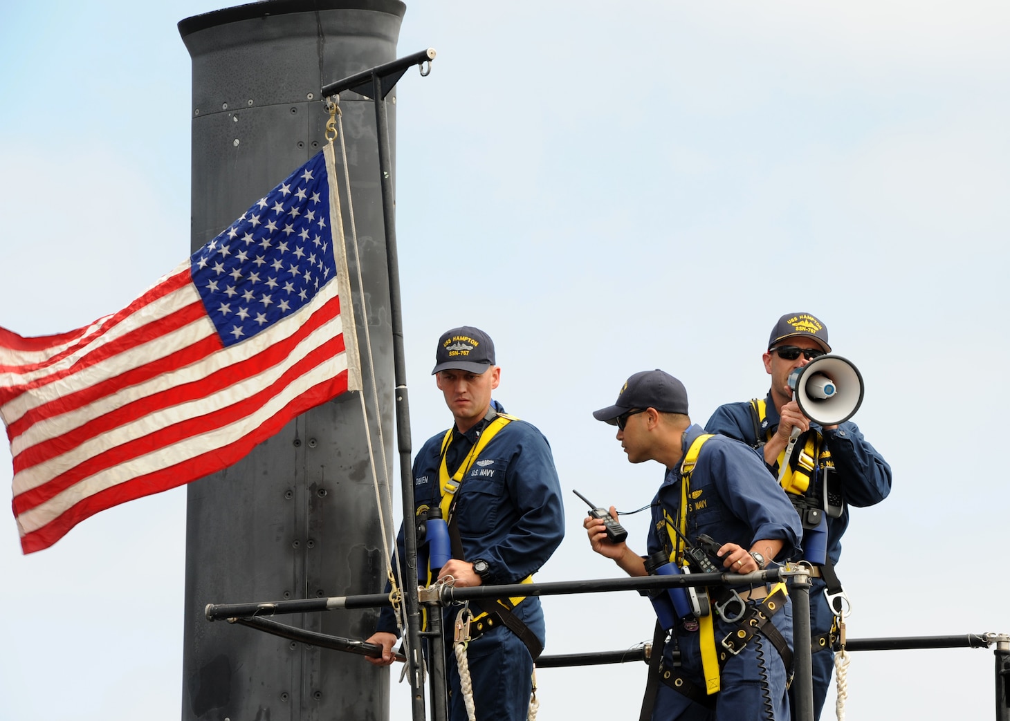 SAN DIEGO (June 18, 2013) Cmdr. Lincoln Reifsteck, commanding officer of the Los Angeles-class attack submarine USS Hampton (SSN 767), stands on the conning tower as the boat departs for a scheduled six-month deployment to the western Pacific region in support of the Chief of Naval Operations' Maritime Strategy, which includes maritime security, forward presence, sea control, and power projection. Hampton was commissioned November 16, 1993 and is named after Hampton, Iowa, S.C. and Va. Displacing more than 6,900 tons, Hampton has a crew of nearly 140 Sailors and is one of six Los Angeles-class, fast-attack submarines homeported in San Diego. U.S. Navy photo by Mass Communication Specialist 2nd Class Kyle Carlstrom. (Released)