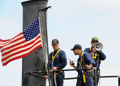 SAN DIEGO (June 18, 2013) Cmdr. Lincoln Reifsteck, commanding officer of the Los Angeles-class attack submarine USS Hampton (SSN 767), stands on the conning tower as the boat departs for a scheduled six-month deployment to the western Pacific region in support of the Chief of Naval Operations' Maritime Strategy, which includes maritime security, forward presence, sea control, and power projection. Hampton was commissioned November 16, 1993 and is named after Hampton, Iowa, S.C. and Va. Displacing more than 6,900 tons, Hampton has a crew of nearly 140 Sailors and is one of six Los Angeles-class, fast-attack submarines homeported in San Diego. U.S. Navy photo by Mass Communication Specialist 2nd Class Kyle Carlstrom. (Released)