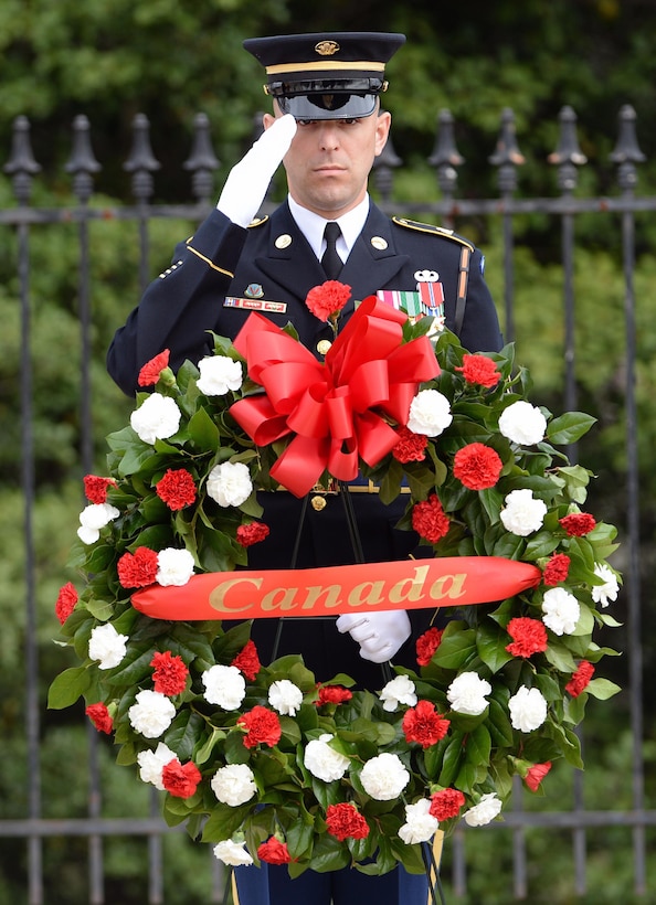 An honor guard member salutes during a ceremony in which Canadian Prime Minister Justin Trudeau is placing a wreath at the Tomb of the Unknown Soldier at Arlington National Cemetery in Arlington, Va., March 11, 2016. DoD photo by Marvin Lynchard