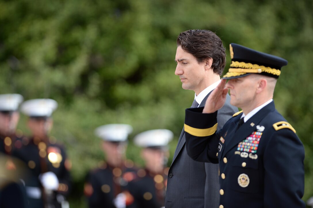 Canadian Prime Minister Justin Trudeau observes a moment of silence with Army Maj. Gen. Bradley A. Becker after placing a wreath at the Tomb of the Unknown Soldier at Arlington National Cemetery in Arlington, Va., March 11, 2016. Becker is the commanding general of the Army Military District of Washington. DoD photo by Marvin Lynchard
