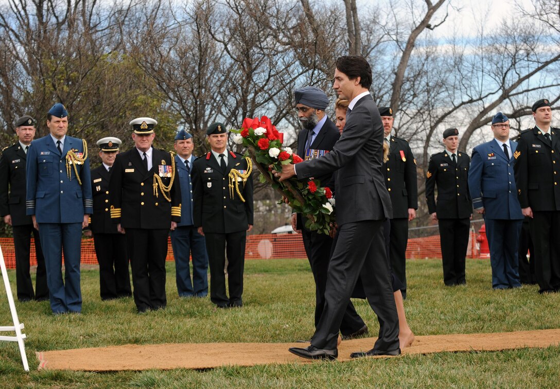 Canadian Prime Minister Justin Trudeau; his wife, Sophie Gregoire-Trudeau; and Canadian Defense Minister Harjit Sajjan carry a wreath to place at the Tomb of the Unknown Soldier at Arlington National Cemetery in Arlington, Va., March 11, 2016. DoD photo by Marvin Lynchard