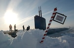 North Polar Region (Apr. 19, 2004) - The crew of the Los Angeles-class attack submarine USS Hampton (SSN 767) posted a sign reading "North Pole" made by the crew after surfacing in the polar ice cap region. Hampton and the Royal Navy Trafalgar class attack submarine HMS Tireless took part in ICEX 04, a joint operational exercise beneath the polar ice cap. Both the Tireless and Hampton crews met on the ice, including scientists traveling aboard both submarines to collect data and perform experiments. The Ice Exercise demonstrates the U.S. and British Submarine Force's ability to freely navigate in all international waters, including the Arctic. U.S. Navy photo by Chief Journalist Kevin Elliott. (RELEASED) 