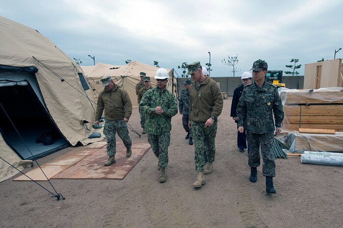 BUSAN, Republic of Korea (March 9, 2016) - U.S. Navy Lt. Van Nguyen, assigned to Naval Mobile Construction Battalion (NMCB) 133, speaks with Rear. Adm. Bill Byrne, commander, U.S. Naval Forces Korea (CNFK), during a tour of a joint U.S. and ROK Seabee construction site during exercise Foal Eagle 2016. U.S. Navy Seabees, assigned to Naval Mobile Construction Battalion (NMCB) 133, and ROK Seabees are working hand-in-hand to construct various expeditionary facilities during the exercise. Foal Eagle is an annual, bilateral training exercise designed to enhance the readiness of U.S. and ROK forces, and their ability to work together during a crisis. 