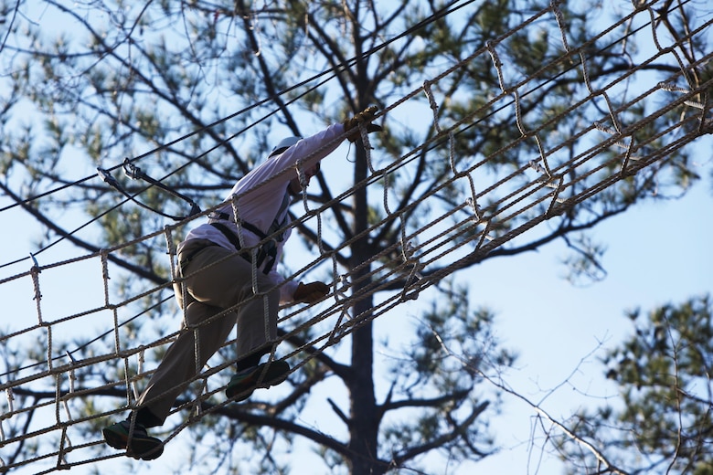 Chief Warrant Officer Brian P. Randolph scales a rope bridge during the Devil Dog Dare Challenge Course at Marine Corps Air Station Cherry Point, N.C., March 10, 2016. The Devil Dog Dare Challenge Course was designed for Marines and Sailors to get engaged in Operation Adrenaline Rush. OAR is a training tool designed to introduce Marines to activities that serve as alternatives to uncharacteristic behaviors often associated with incidents involving recently deployed Marines. Randolph is a telecommunications systems engineering officer with G-6, 2nd Marine Aircraft Wing. (U.S. Marine Corps photo by Pfc. Nicholas P. Baird/Released)