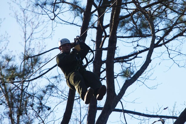 Cpl. Wesley J. Geary glides down a zip line during the Devil Dog Dare Challenge Course at Marine Corps Air Station Cherry Point, N.C., March 10, 2016. The Devil Dog Dare Challenge Course was designed for Marines and Sailors to get engaged in Operation Adrenaline Rush. OAR is a training tool designed to introduce Marines to activities that serve as alternatives to uncharacteristic behaviors often associated with incidents involving recently deployed Marines. Geary is a data network specialist with G-6, 2nd Marine Aircraft Wing. (U.S. Marine Corps photo by Pfc. Nicholas P. Baird/Released)