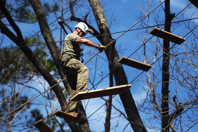 Capt. Timothy G. Otto maneuvers across a wooden rope bridge during the Devil Dog Dare Challenge Course at Marine Corps Air Station Cherry Point, N.C., March 10, 2016. The Devil Dog Dare Challenge Course was designed for Marines and Sailors to get engaged in Operation Adrenaline Rush. OAR is a training tool designed to introduce Marines to activities that serve as alternatives to uncharacteristic behaviors often associated with incidents involving recently deployed Marines. Otto is an electronic maintenance officer with G-6, 2nd Marine Aircraft Wing. (U.S. Marine Corps photo by Pfc. Nicholas P. Baird/Released)