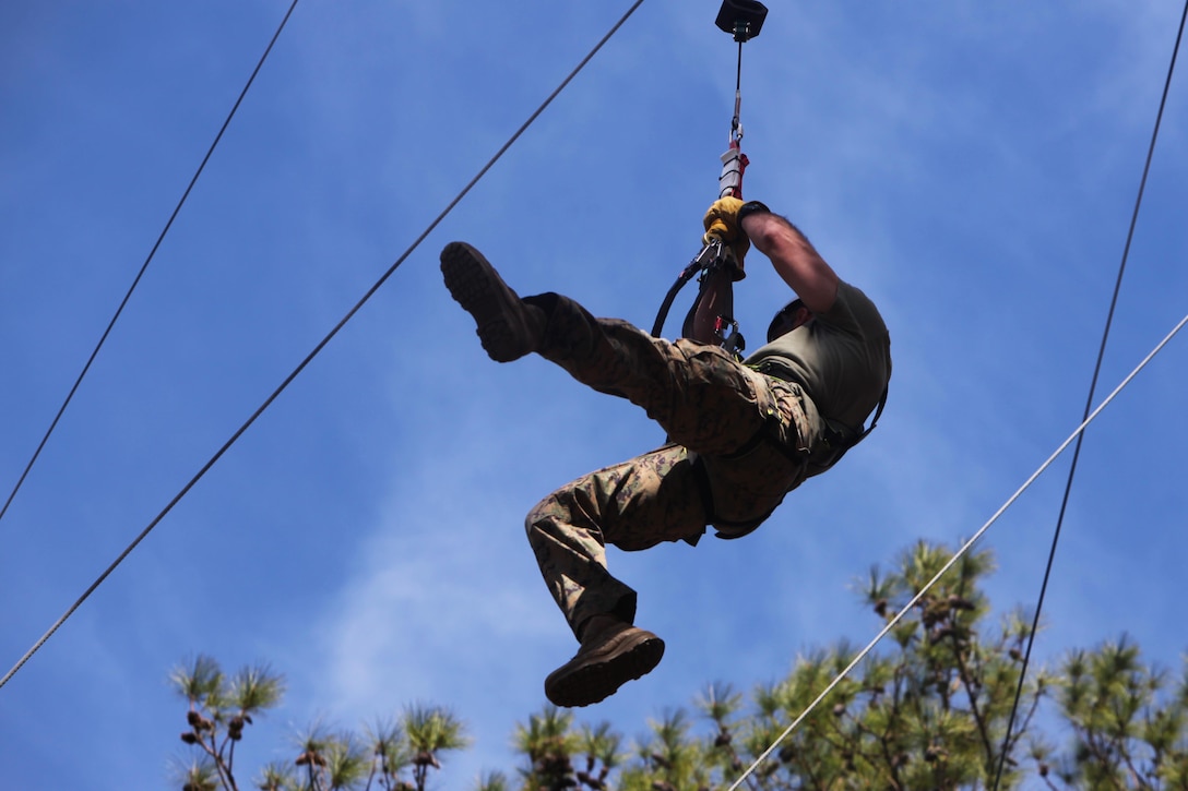 Capt. Timothy G. Otto descends from a 65-foot free fall tower during the Devil Dog Dare Challenge Course at Marine Corps Air Station Cherry Point, N.C., March 10, 2016. The Devil Dog Dare Challenge Course was designed for Marines and Sailors to get engaged in Operation Adrenaline Rush. OAR is a training tool designed to introduce Marines to activities that serve as alternatives to uncharacteristic behaviors often associated with incidents involving recently deployed Marines. Otto is an electronic maintenance officer with G-6, 2nd Marine Aircraft Wing. (U.S. Marine Corps photo by Pfc. Nicholas P. Baird/Released)