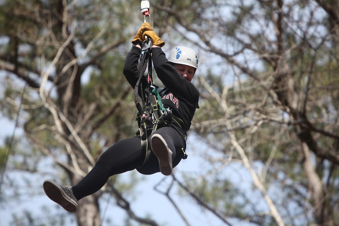 Sgt. Laura B. Freitas descends from a 65-foot free fall tower during the Devil Dog Dare Challenge Course at Marine Corps Air Station Cherry Point, N.C., March 10, 2016. The Devil Dog Dare Challenge Course was designed for Marines and Sailors to get engaged in Operation Adrenaline Rush. OAR is a training tool designed to introduce Marines to activities that serve as alternatives to uncharacteristic behaviors often associated with incidents involving recently deployed Marines. Freitas is a cyber network operator, G-6, 2nd Marine Aircraft Wing. (U.S. Marine Corps photo by Pfc. Nicholas P. Baird/Released)