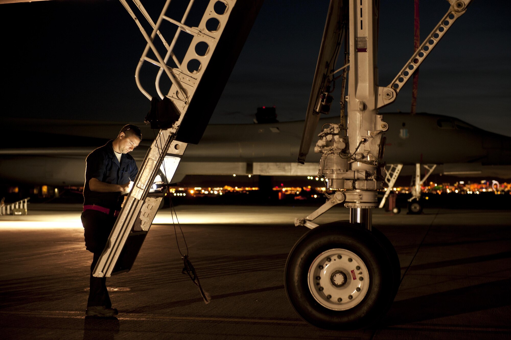 Senior Airman Jeremy Holloway, a dedicated crew chief assigned to the 28th Aircraft Maintenance Squadron, Ellsworth Air Force Base, S.D., updates maintenance records for a B-1 Lancer prior to a Red Flag 16-2 night training sortie March, 10, 2016 at Nellis Air Force Base, Nev. Aircraft maintainers work through the night to ensure aircrews continue to receive an effective and safe training experience. (U.S. Air Force photo by Senior Airman Joshua Kleinholz)