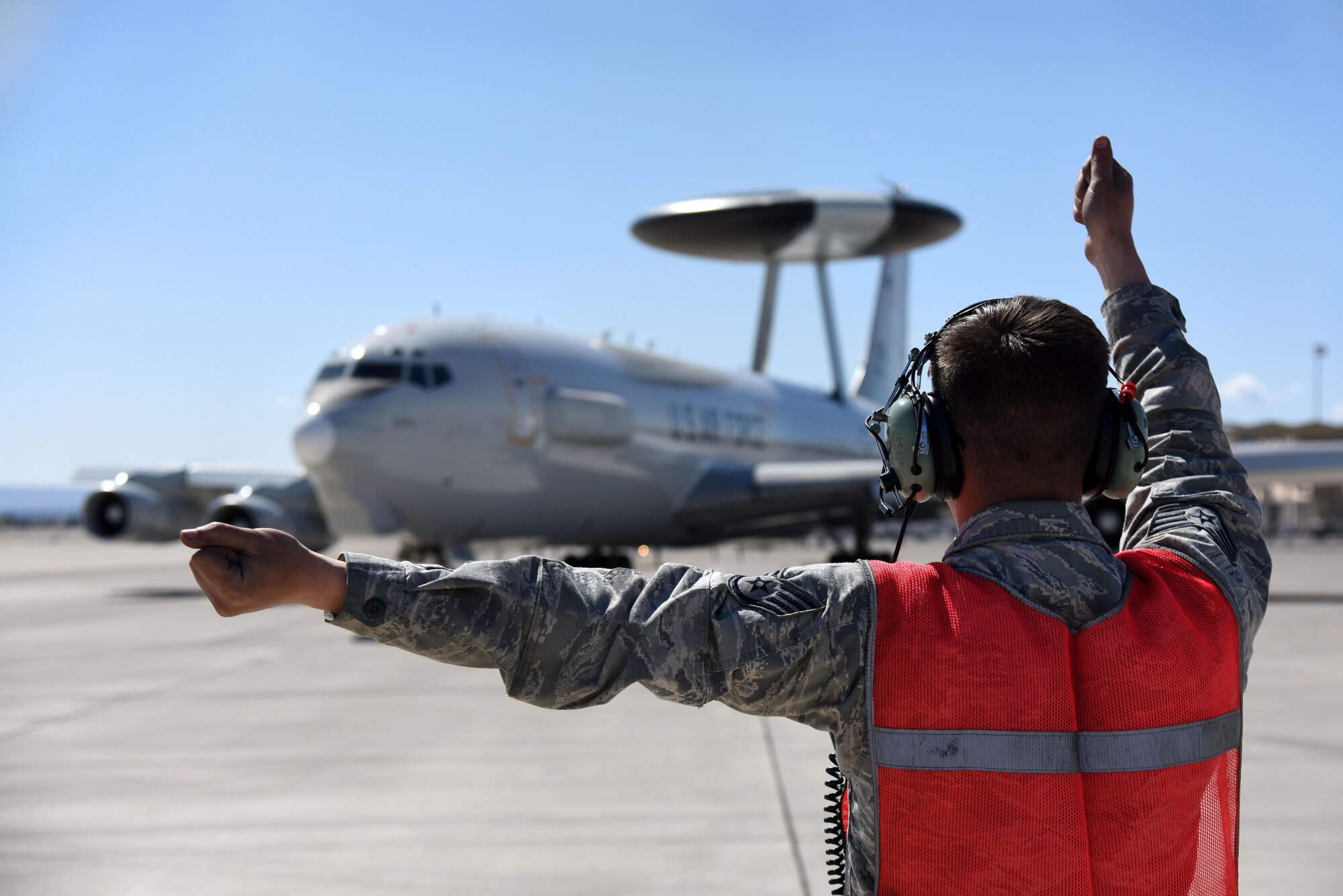 Staff Sgt. Christopher Longueira, 552nd Aircraft Maintenance Squadron dedicated crew chief, marshals an E-3 Sentry to the runway March 8, 2016, during Red Flag 16-2 at Nellis Air Force Base, Nevada. The radar and other sensors aboard the E-3 provide deep-look surveillance, warning, interception control and airborne battle management. (U.S. Air Force photo/Staff Sgt. Chuck Broadway)

