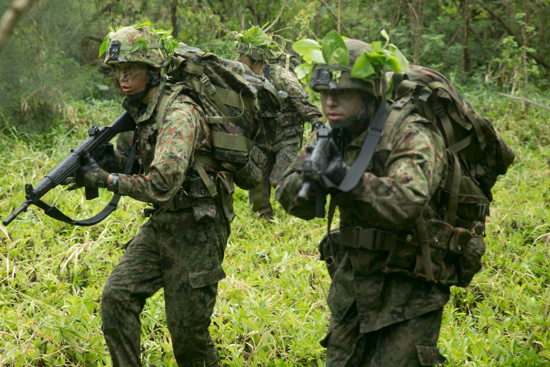 Members of the Japan Ground Self-Defense Force secure an outpost during a raid mission at Kin Blue, Okinawa Japan, Mar. 11. The intent of the mission was to stop a mock smuggling organization. The JGSDF members incorporated a variety of techniques they observed from 3rd Reconnaissance Battalion, 3rd Marine Division, III Marine Expeditionary Force. The techniques include scout swimming, nautical navigation, beach securing, and reconnaissance. The members are with the 43rd Infantry Regiment.